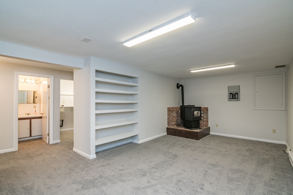 45 Cave Hill Road Leverett, MA 01054 - Photo 32 of 42 a living room with furniture and a flat screen tv