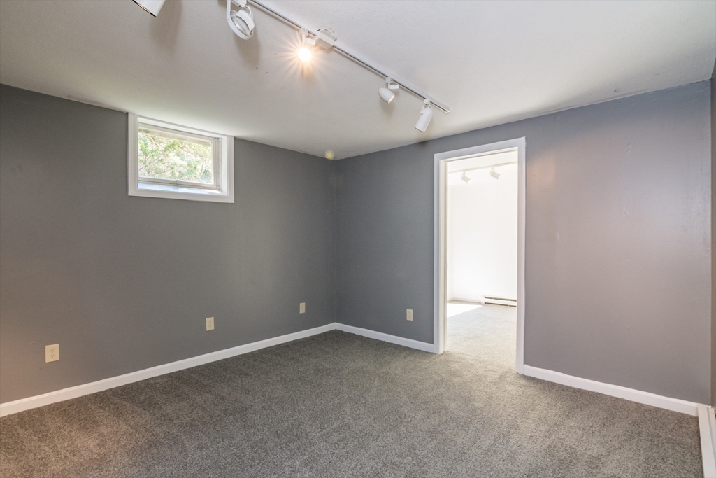 45 Cave Hill Road Leverett, MA 01054 - Photo 35 of 42 an empty room with a window and a ceiling fan