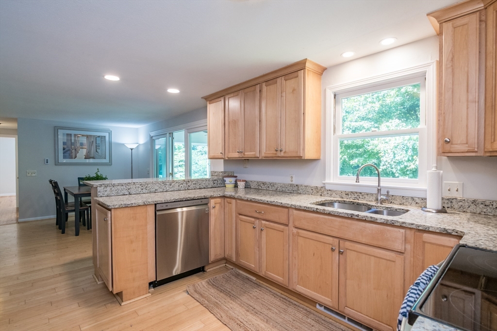 45 Cave Hill Road Leverett, MA 01054 - Photo 6 of 42 a kitchen with kitchen island granite countertop wooden floors and white cabinets