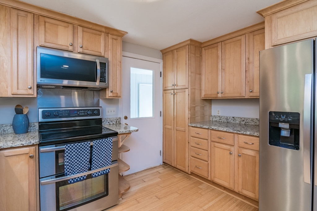 45 Cave Hill Road Leverett, MA 01054 - Photo 7 of 42 a kitchen with stainless steel appliances a stove a microwave a sink and cabinets