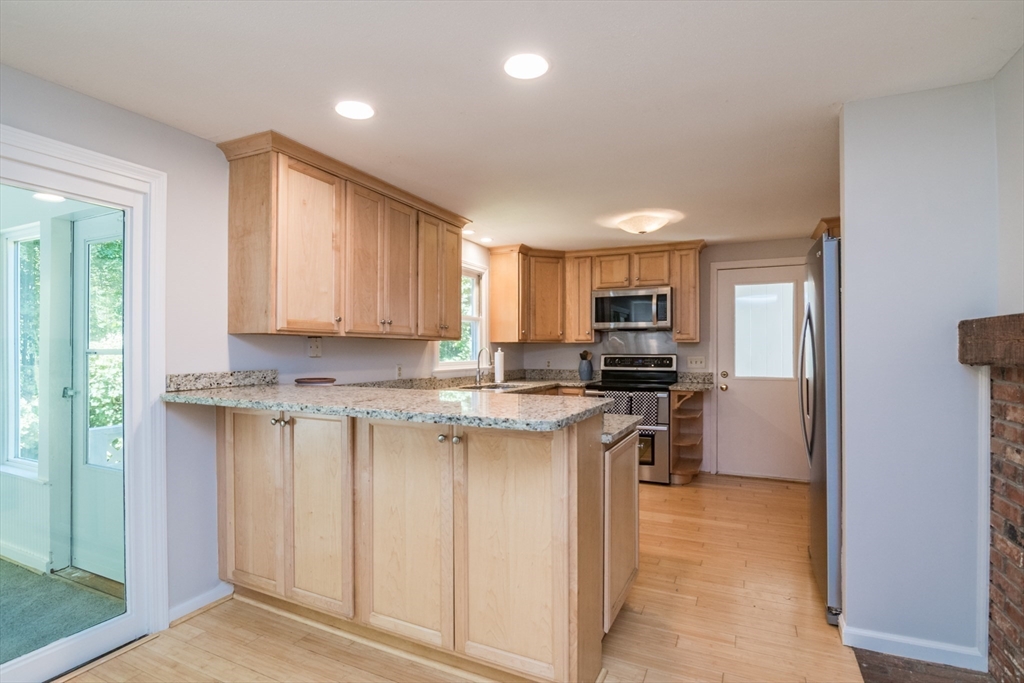 45 Cave Hill Road Leverett, MA 01054 - Photo 8 of 42 a kitchen with stainless steel appliances granite countertop a stove a sink and a refrigerator