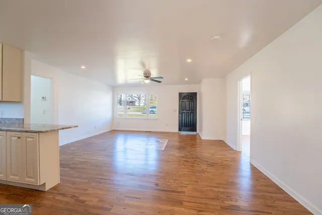 a view of a room with wooden floor and a wall painting