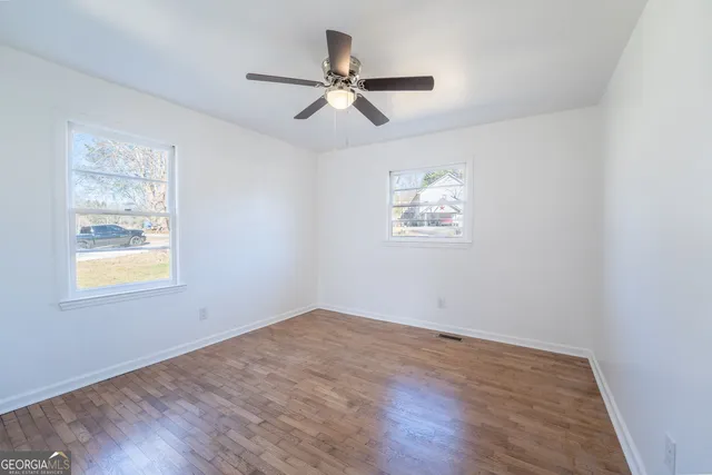 a bathroom with a granite countertop toilet a sink and a shower