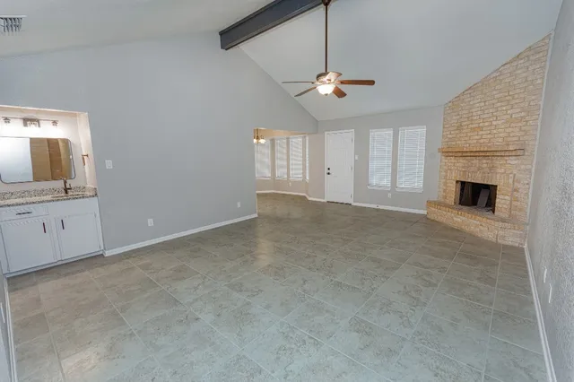 a view of an empty room with a kitchen