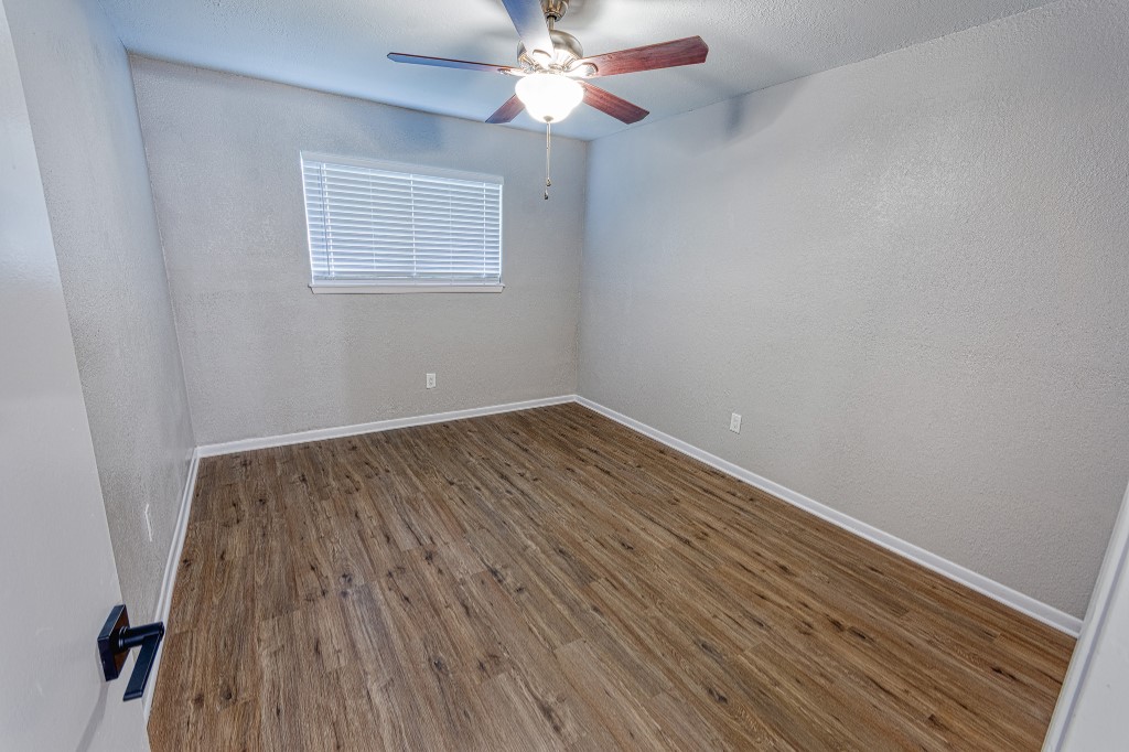 7017 Keystone Drive Corpus Christi, TX 78413 - Photo 16 of 21 wooden floor in an empty room with a window