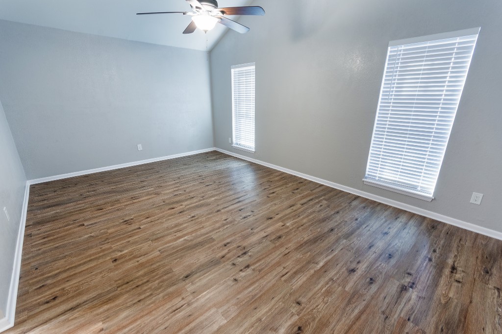 7017 Keystone Drive Corpus Christi, TX 78413 - Photo 18 of 21 wooden floor in an empty room with a window
