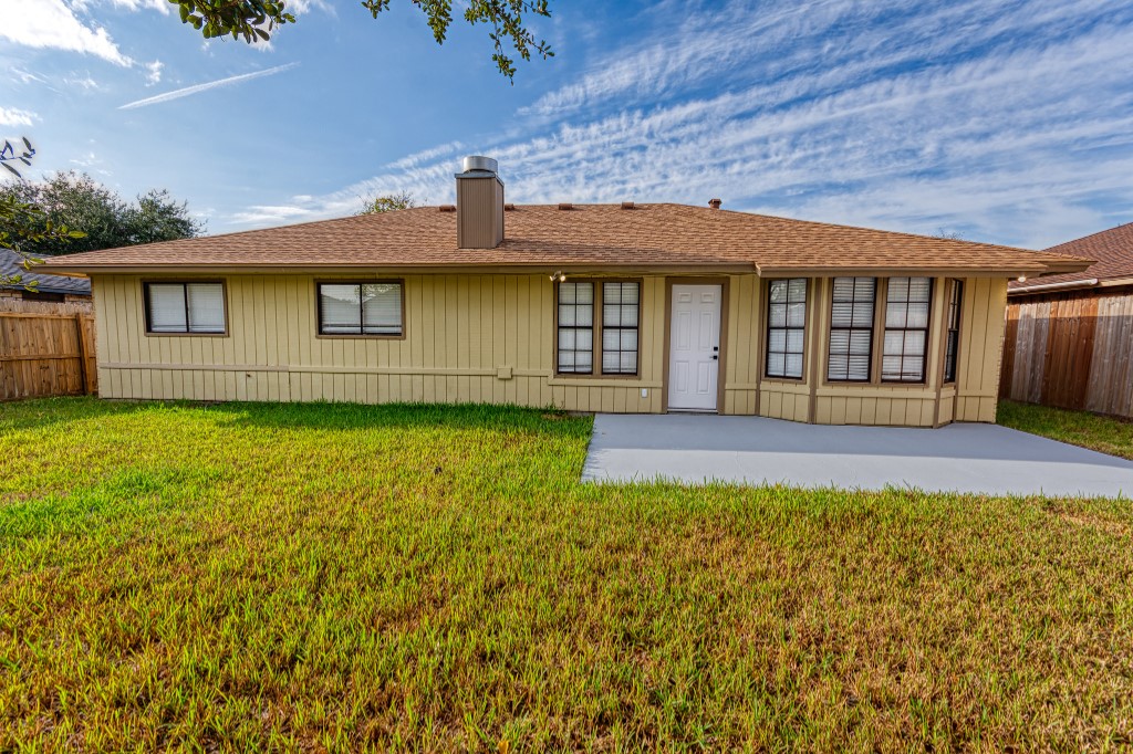 7017 Keystone Drive Corpus Christi, TX 78413 - Photo 20 of 21 a view of a house with a yard and a garage