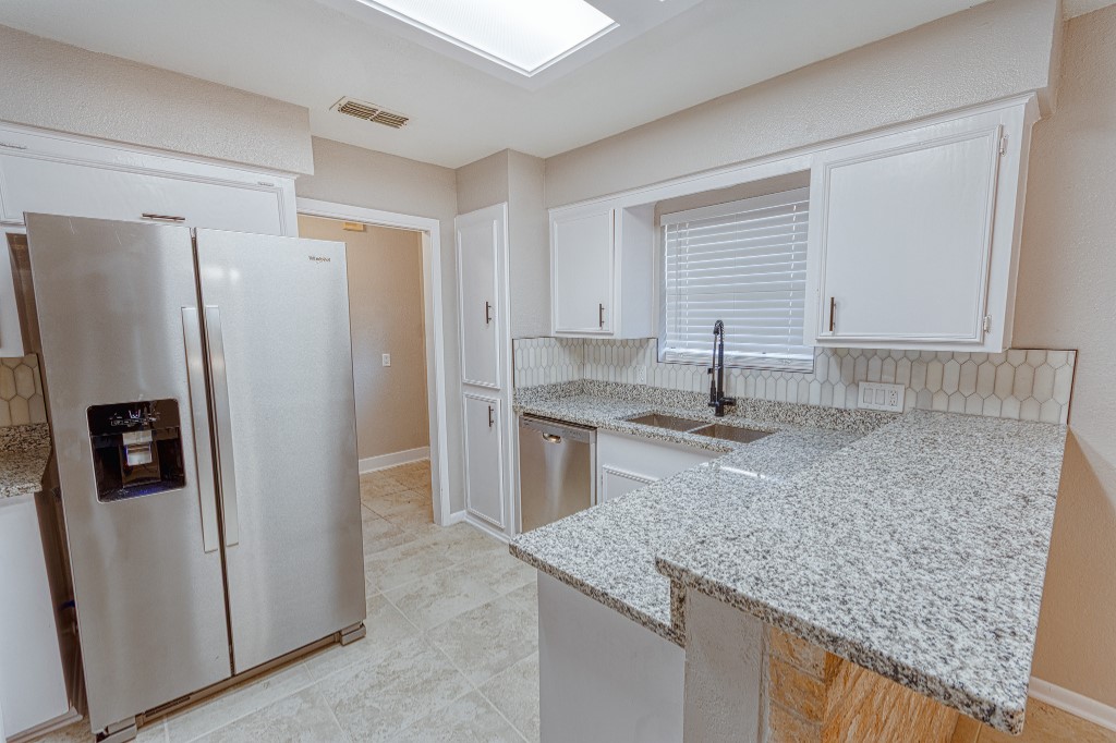 7017 Keystone Drive Corpus Christi, TX 78413 - Photo 6 of 21 a kitchen with stainless steel appliances granite countertop a sink stove and refrigerator