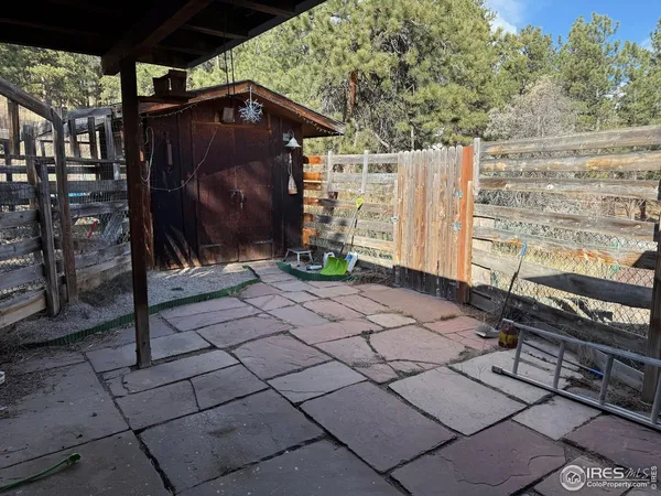 a view of a living room with a floor to ceiling window and tree