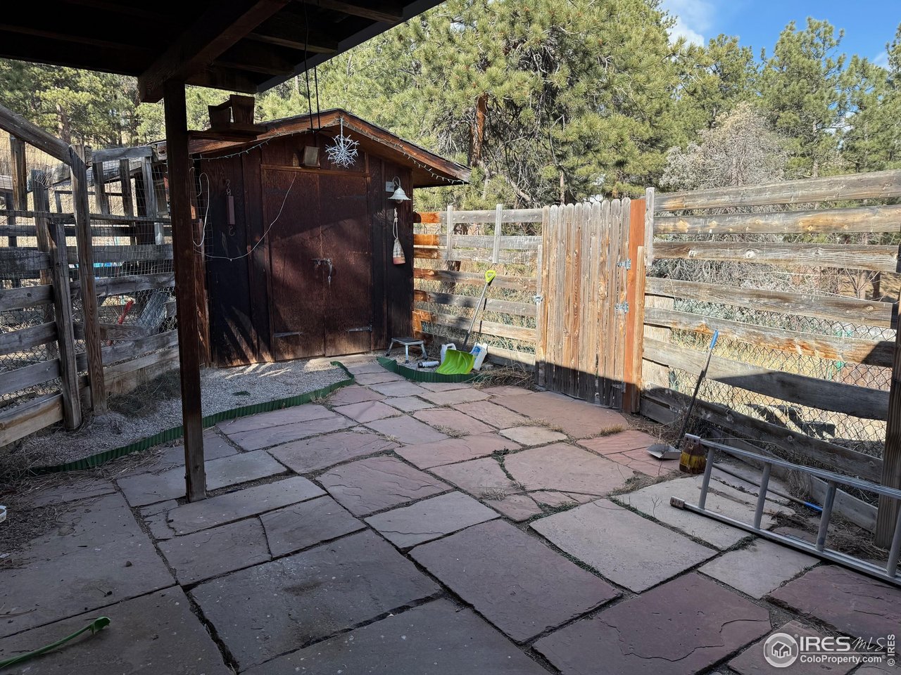358 Kelly Road East Boulder, CO 80302 - Photo 14 of 16 a view of a wooden door with a bench
