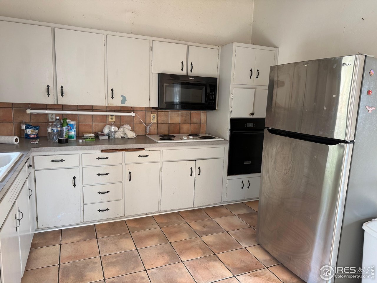 358 Kelly Road East Boulder, CO 80302 - Photo 5 of 16 a kitchen with stainless steel appliances a refrigerator sink and microwave