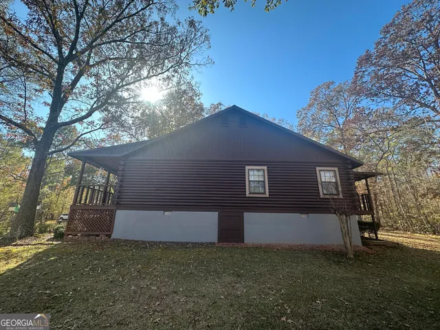 a front view of house with yard and trees