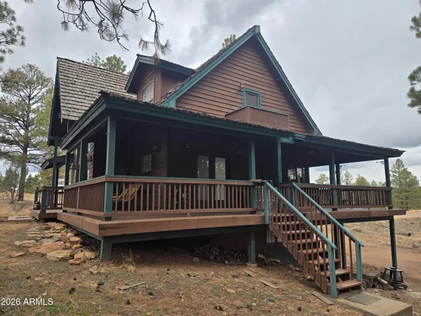 a view of a house with a wooden deck