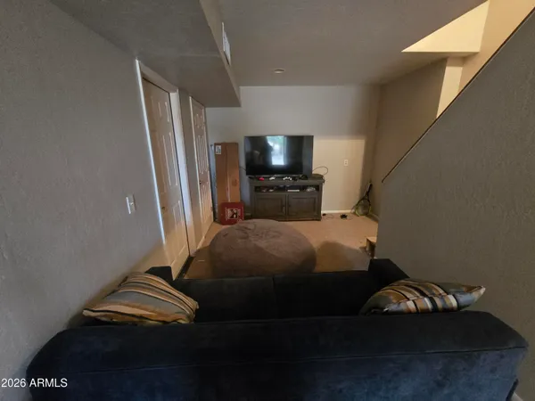 a bedroom with a bed and a television