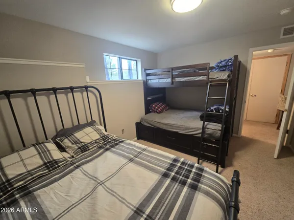 a bedroom with furniture and a window