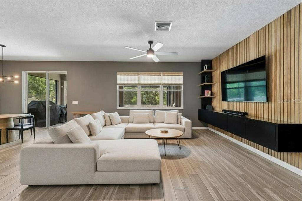 18078 Romanesque Court Spring Hill, FL 34610 - Photo 2 of 81 a living room with furniture and a flat screen tv