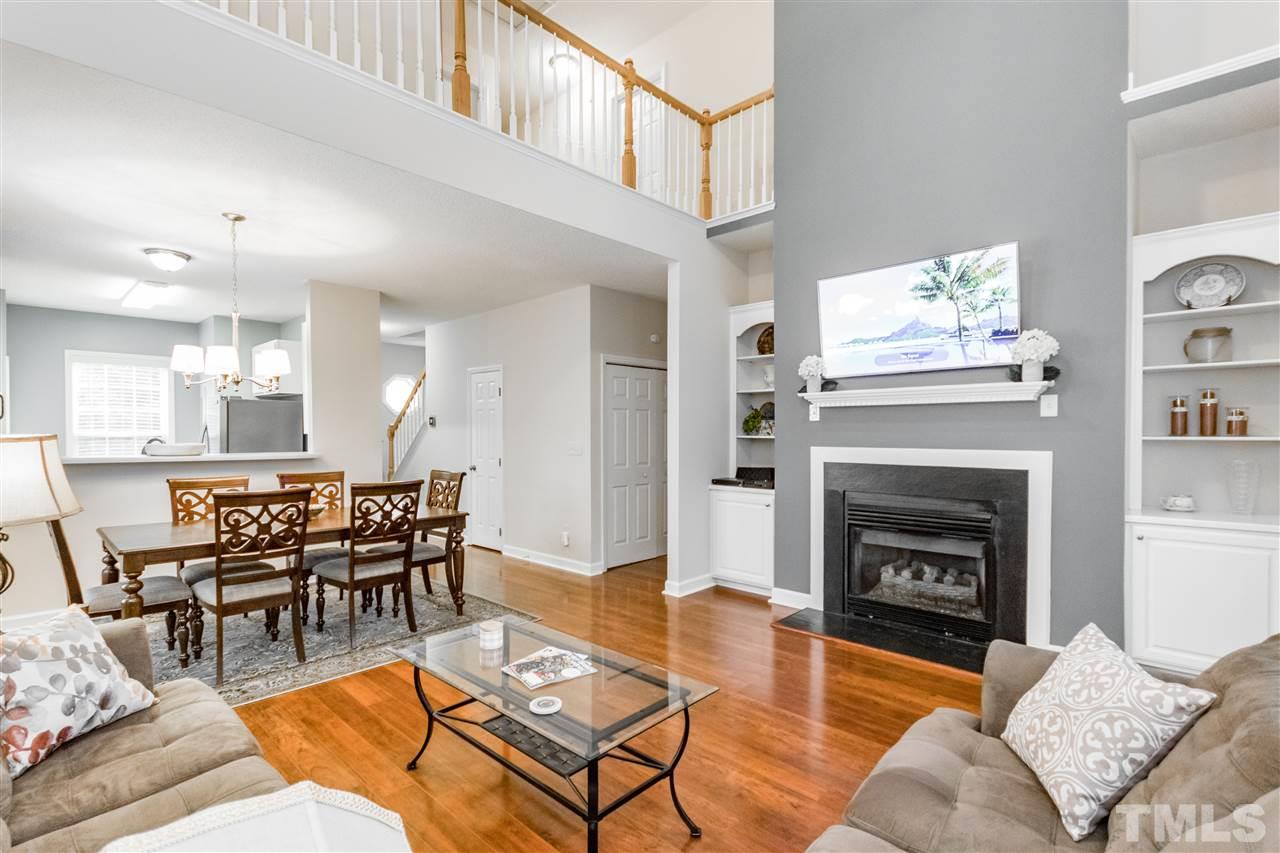 1913 Crag Burn Lane Raleigh, NC 27604 - Photo 2 of 29 a living room with furniture a fireplace and a table