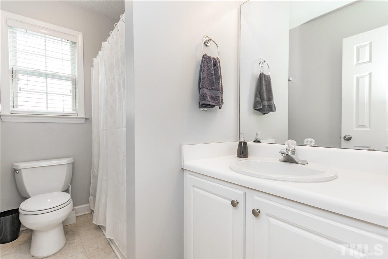 1913 Crag Burn Lane Raleigh, NC 27604 - Photo 11 of 29 a bathroom with a sink vanity mirror and toilet