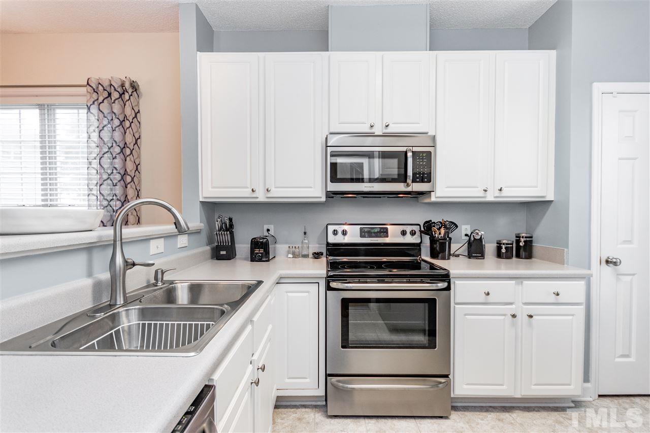 1913 Crag Burn Lane Raleigh, NC 27604 - Photo 12 of 29 a kitchen with granite countertop a sink and a stove top oven