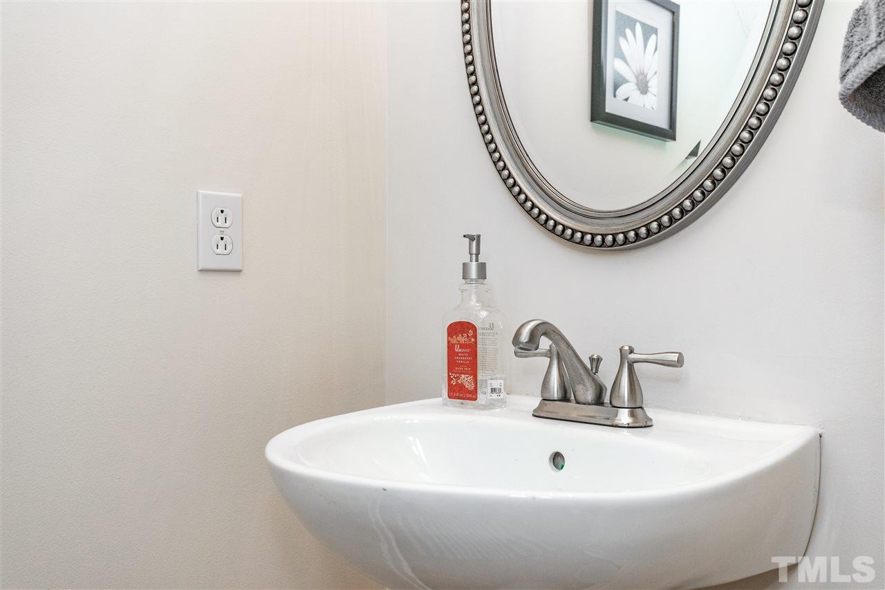 1913 Crag Burn Lane Raleigh, NC 27604 - Photo 15 of 29 a bathroom with a sink and a mirror