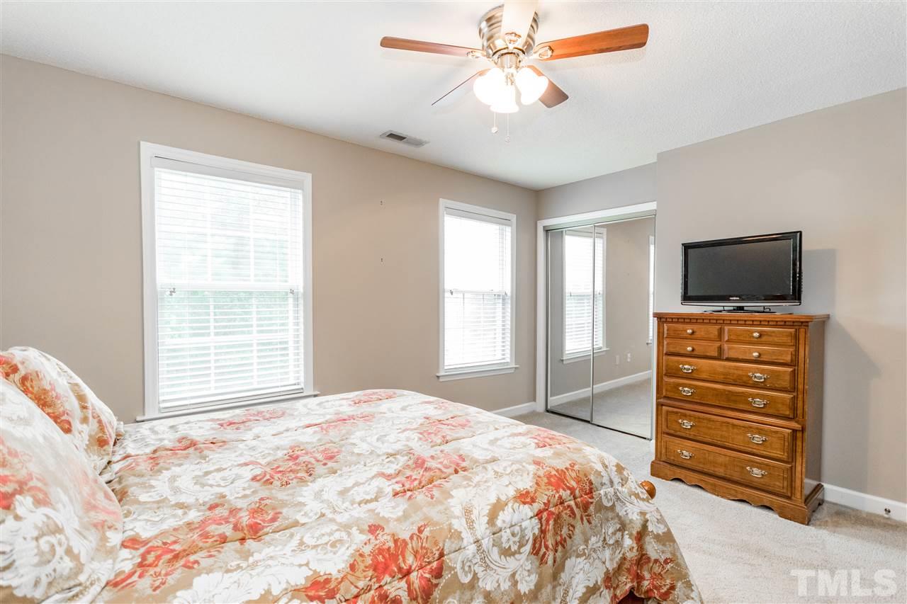1913 Crag Burn Lane Raleigh, NC 27604 - Photo 18 of 29 a bedroom with a bed and a flat screen tv