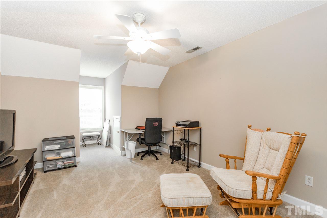1913 Crag Burn Lane Raleigh, NC 27604 - Photo 19 of 29 a living room with furniture a piano and a flat screen tv