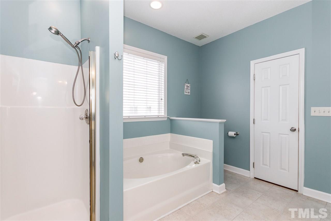1913 Crag Burn Lane Raleigh, NC 27604 - Photo 20 of 29 a bathroom with a bath tub and a shower