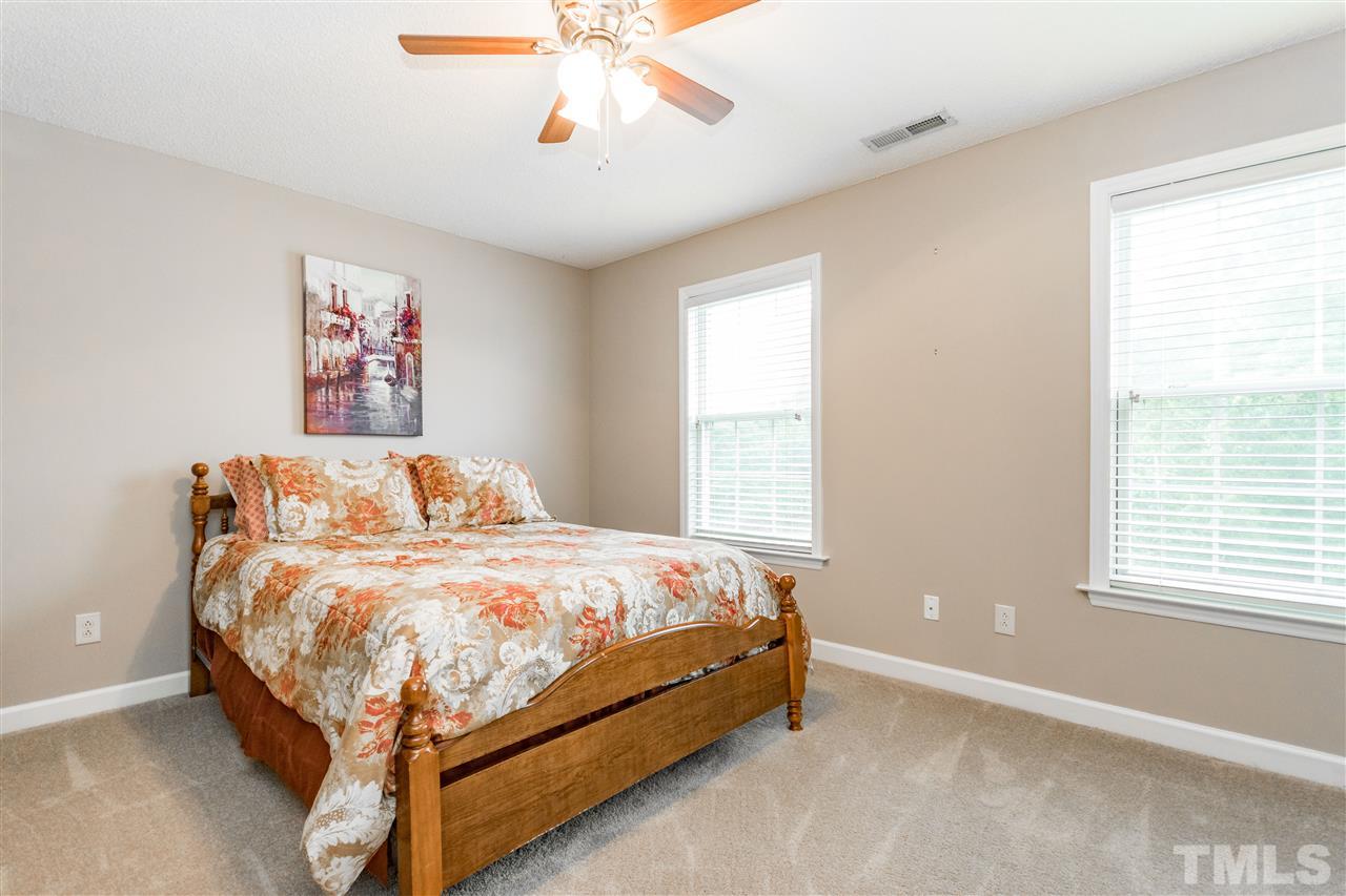 1913 Crag Burn Lane Raleigh, NC 27604 - Photo 22 of 29 a bedroom with a bed and a window