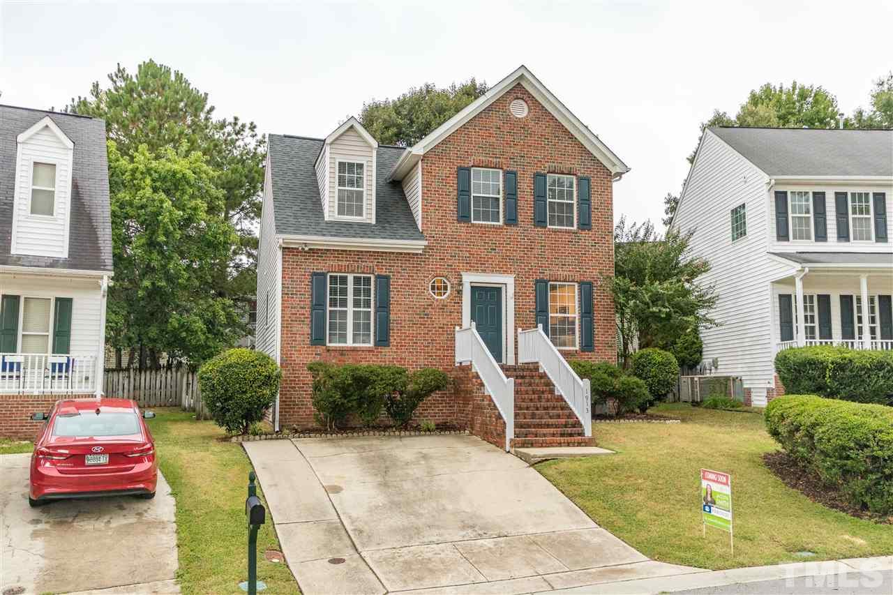 1913 Crag Burn Lane Raleigh, NC 27604 - Photo 29 of 29 a view of a brick house with a yard plants and a table and chair