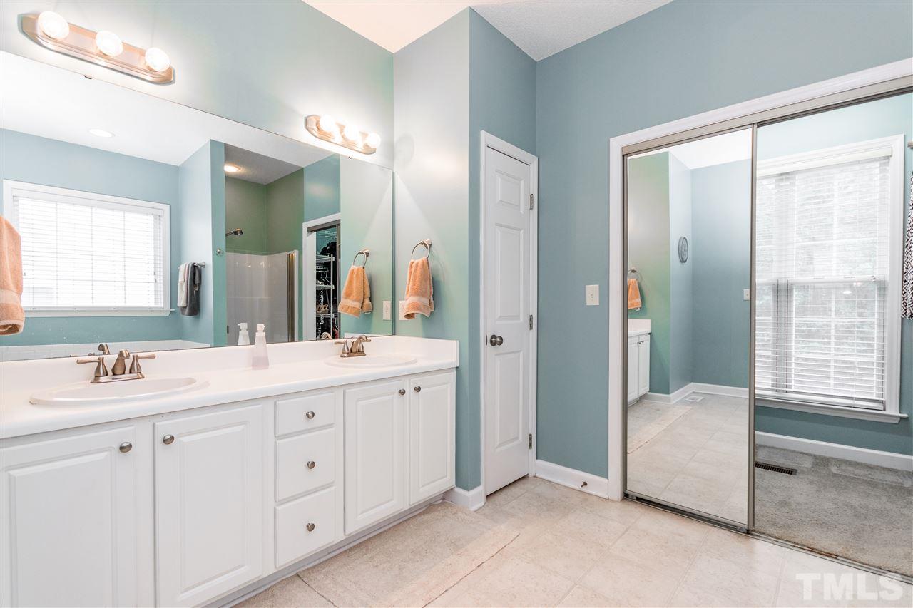 1913 Crag Burn Lane Raleigh, NC 27604 - Photo 8 of 29 a bathroom with a double vanity sink tub and shower