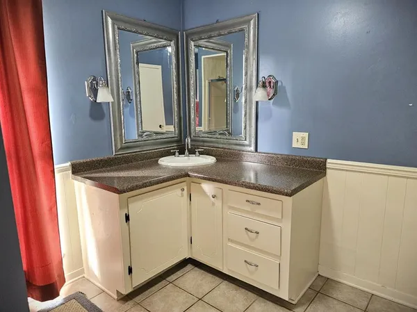 a bathroom with a sink and a mirror