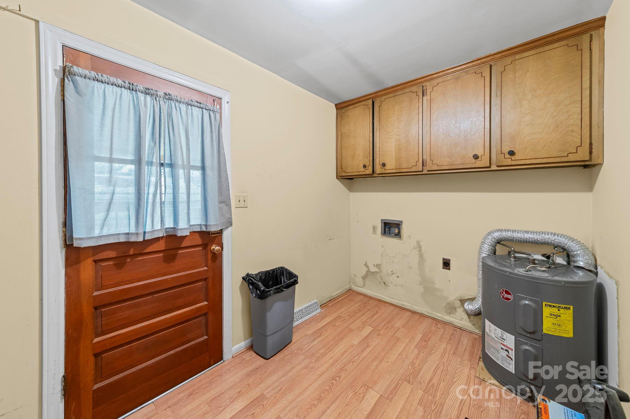 1902 Shady Lane Monroe, NC 28110 - Photo 16 of 36 a room with wooden floor and cabinet