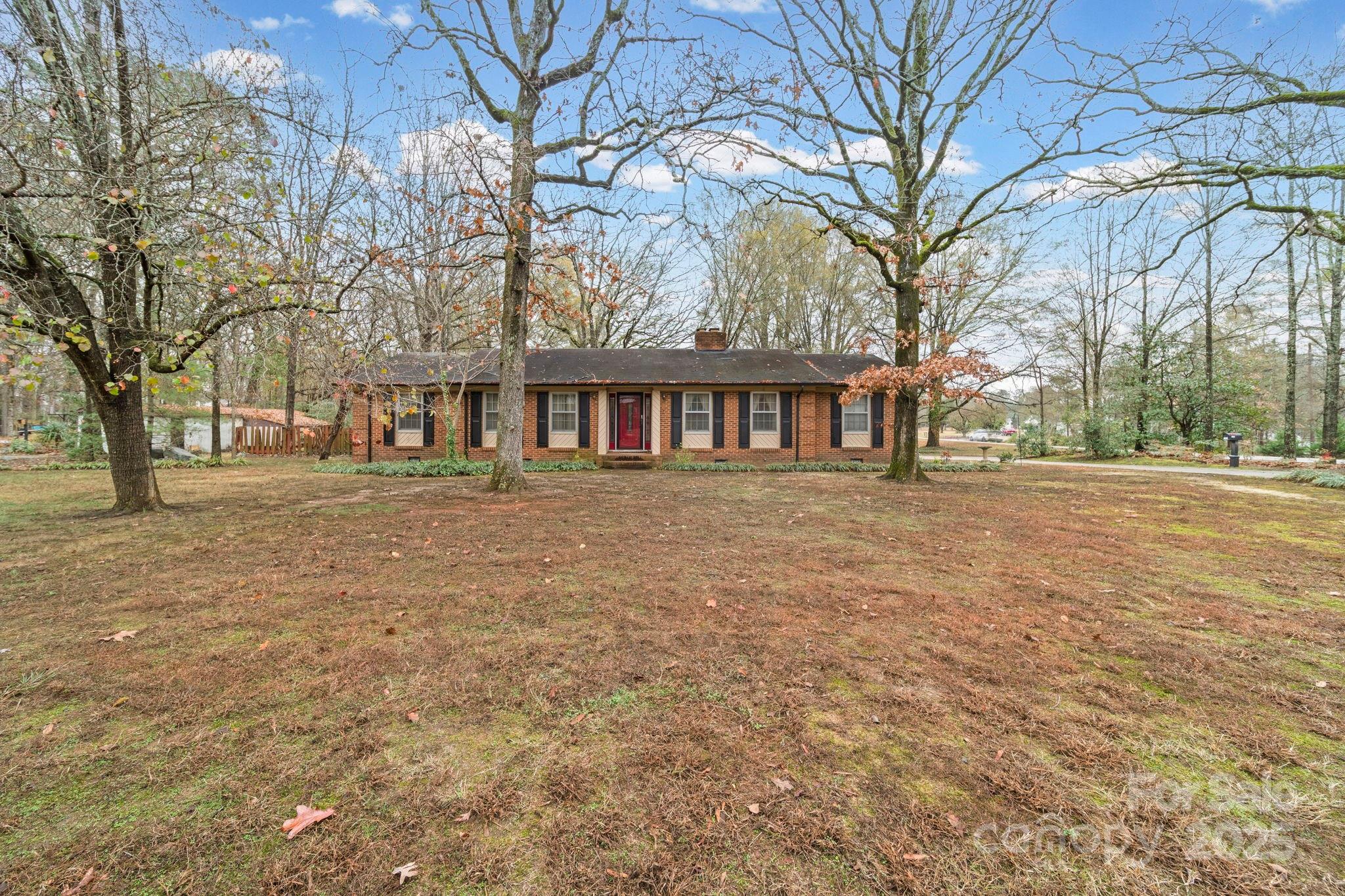 1902 Shady Lane Monroe, NC 28110 - Photo 2 of 36 a front view of a building with large trees