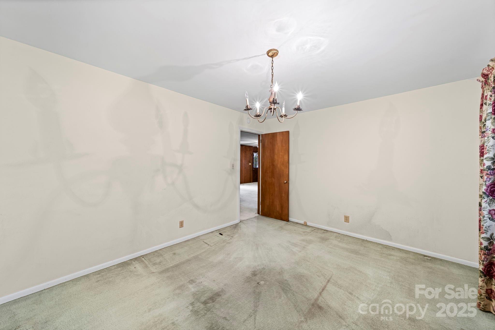 1902 Shady Lane Monroe, NC 28110 - Photo 21 of 36 a view of a hallway with a chandelier