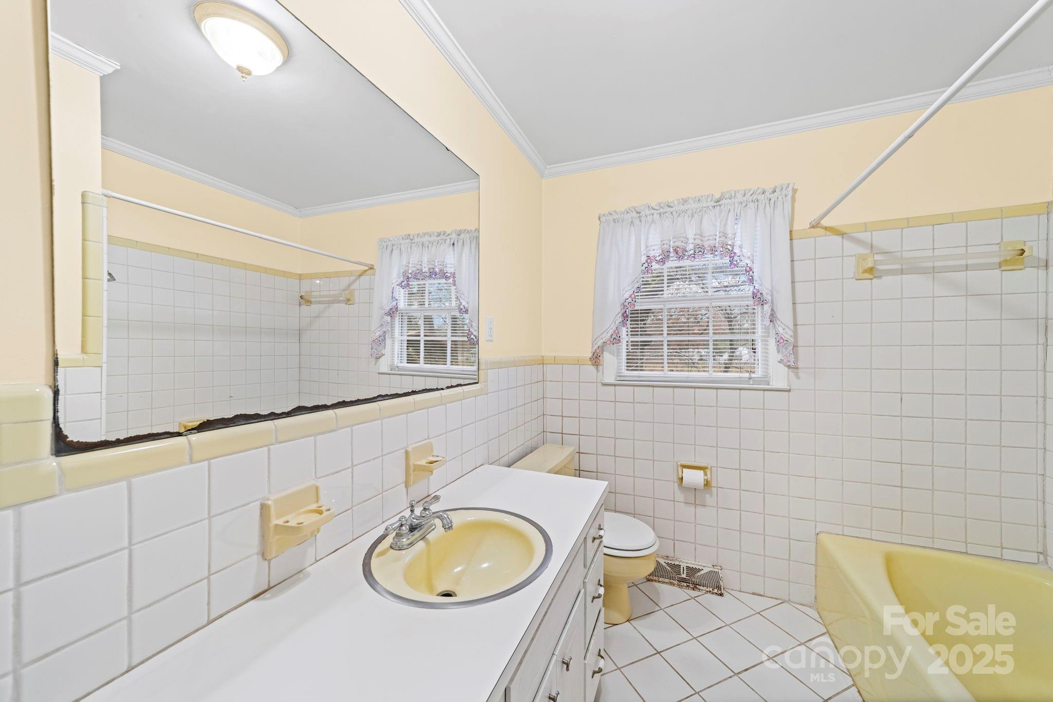 1902 Shady Lane Monroe, NC 28110 - Photo 26 of 36 a bathroom with a granite countertop bathtub sink vanity mirror and toilet