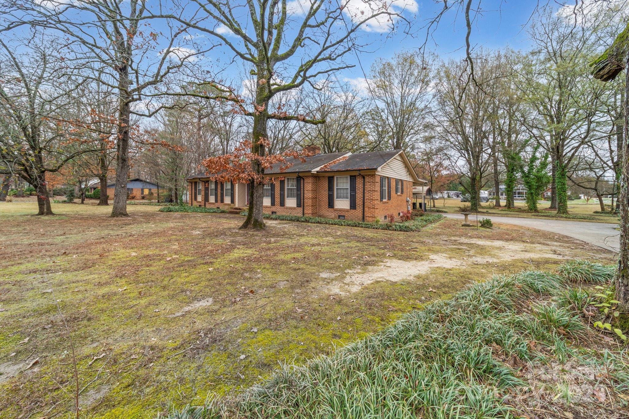 1902 Shady Lane Monroe, NC 28110 - Photo 34 of 36 a front view of residential houses with yard and trees