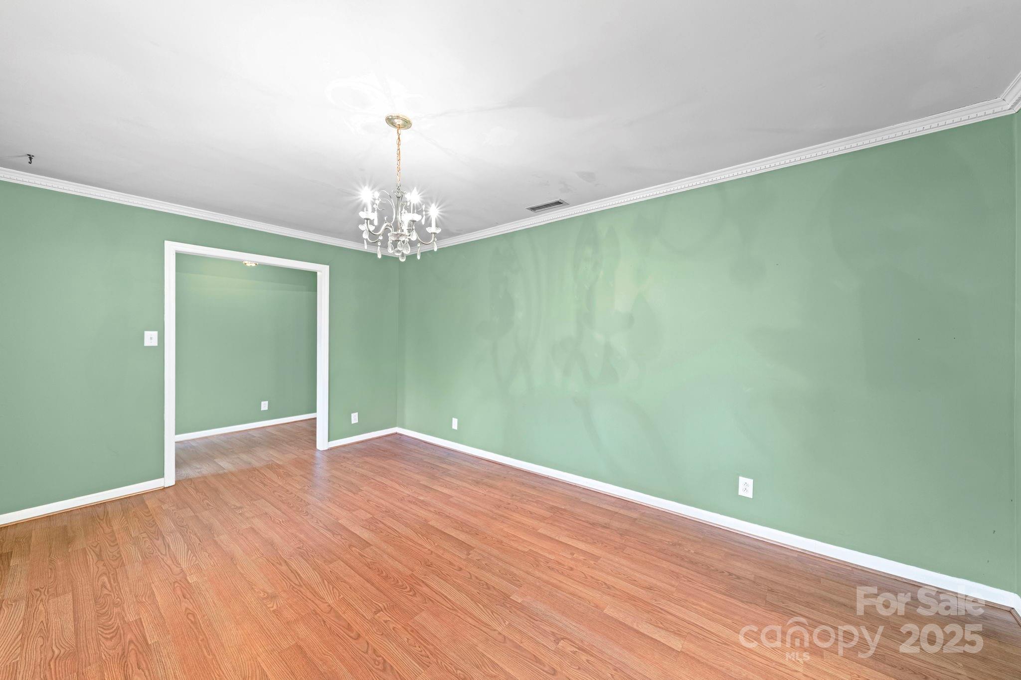 1902 Shady Lane Monroe, NC 28110 - Photo 7 of 36 a view of an empty room with window and chandelier