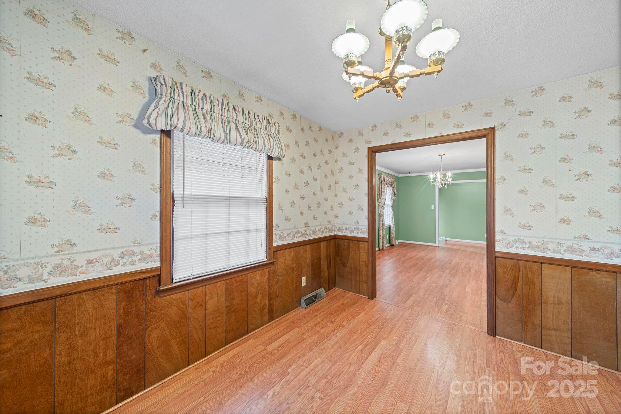 1902 Shady Lane Monroe, NC 28110 - Photo 10 of 36 a view of a room with wooden floor and chandelier