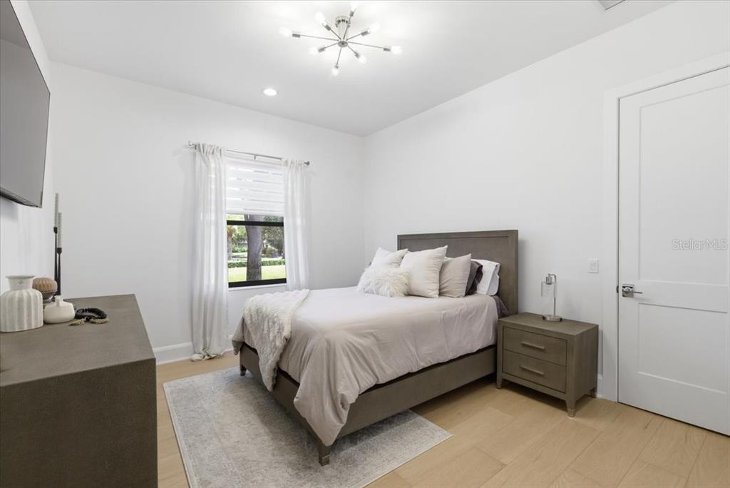 2829 Coastal Range Way Lutz, FL 33559 - Photo 46 of 64 a bedroom with a bed and a chandelier
