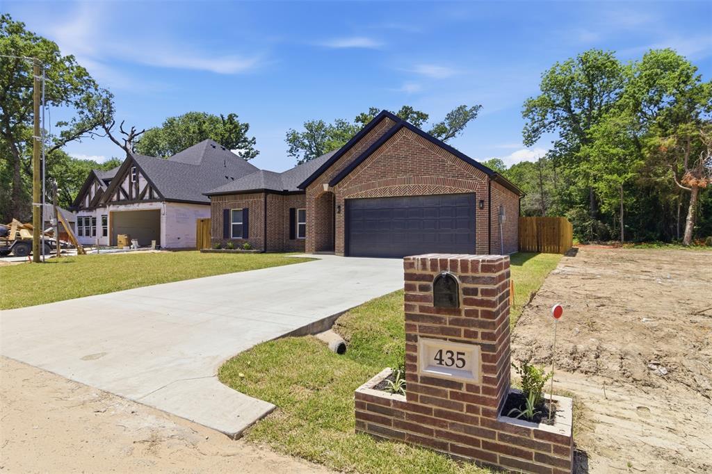 435 Waterboard Road Trinidad, TX 75163 - Photo 2 of 39 Brick exterior featuring a dark grey garage door, dark shingle roof, and contrasting black trim