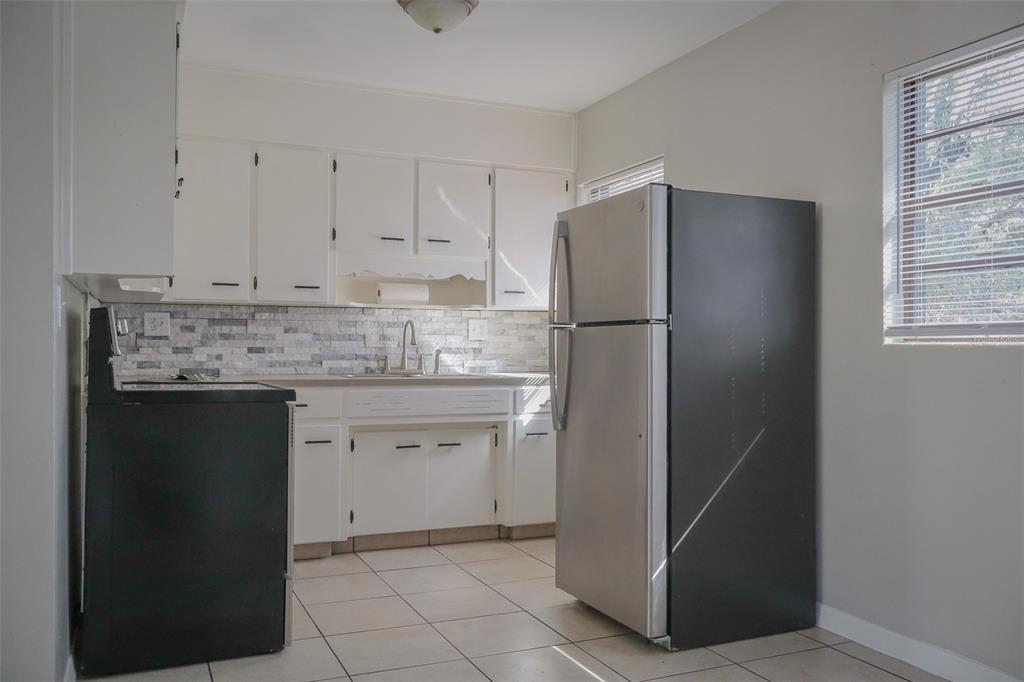 2708 Dixie Road Lakeland, FL 33801 - Photo 7 of 31 a kitchen with a refrigerator and cabinets