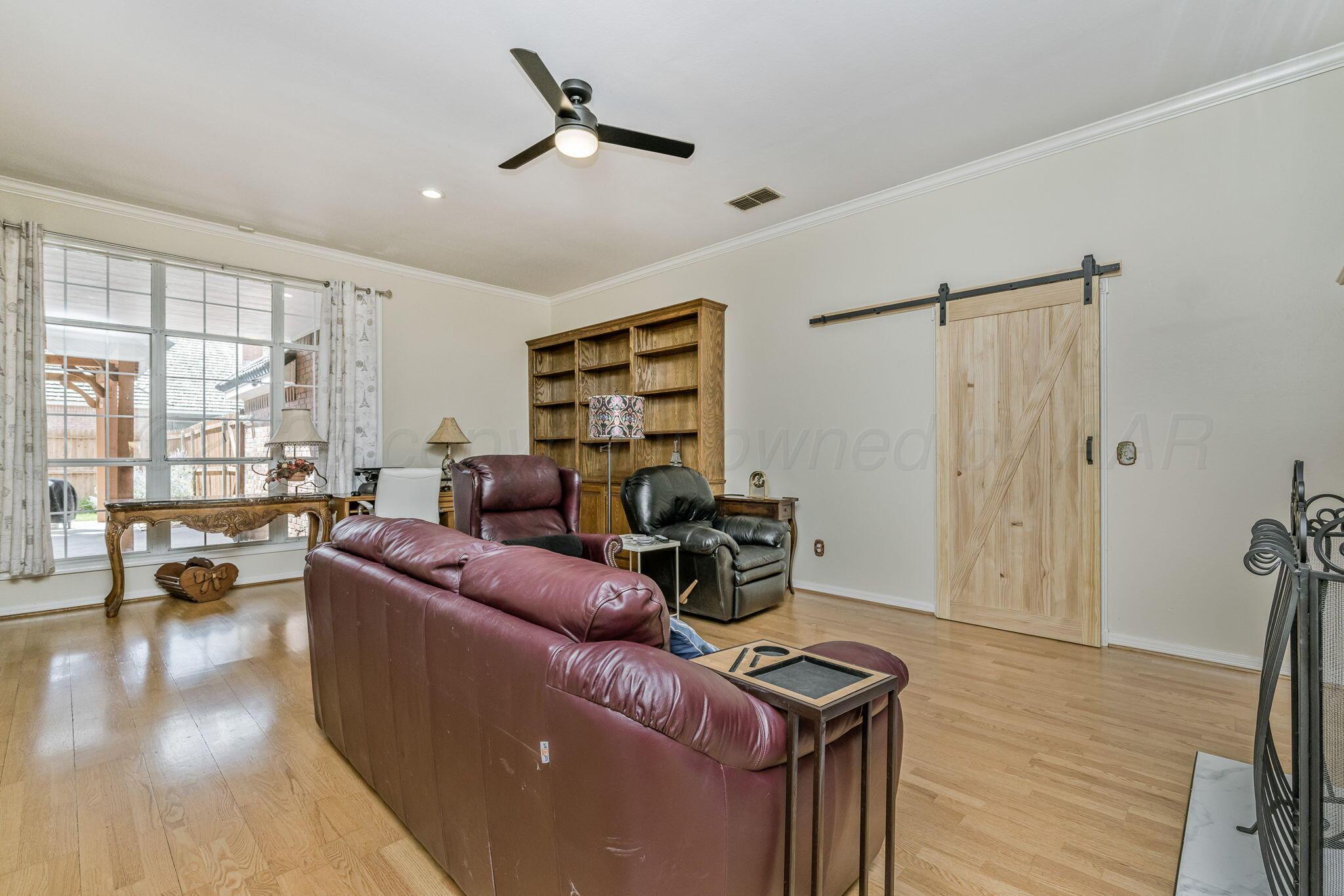 7809 Bent Tree Drive Amarillo, TX 79121 - Photo 12 of 31 a living room with furniture and a wooden floor