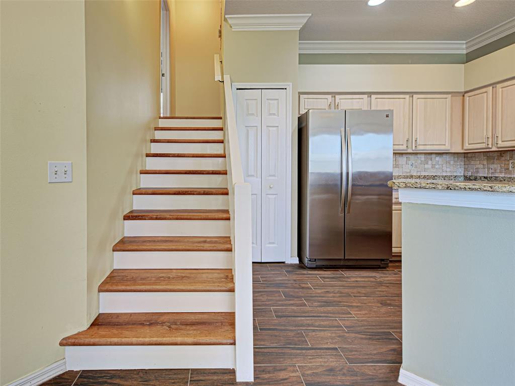 1801 Highland Road Osprey, FL 34229 - Photo 15 of 40 a view of a kitchen with white cabinets and stainless steel appliances