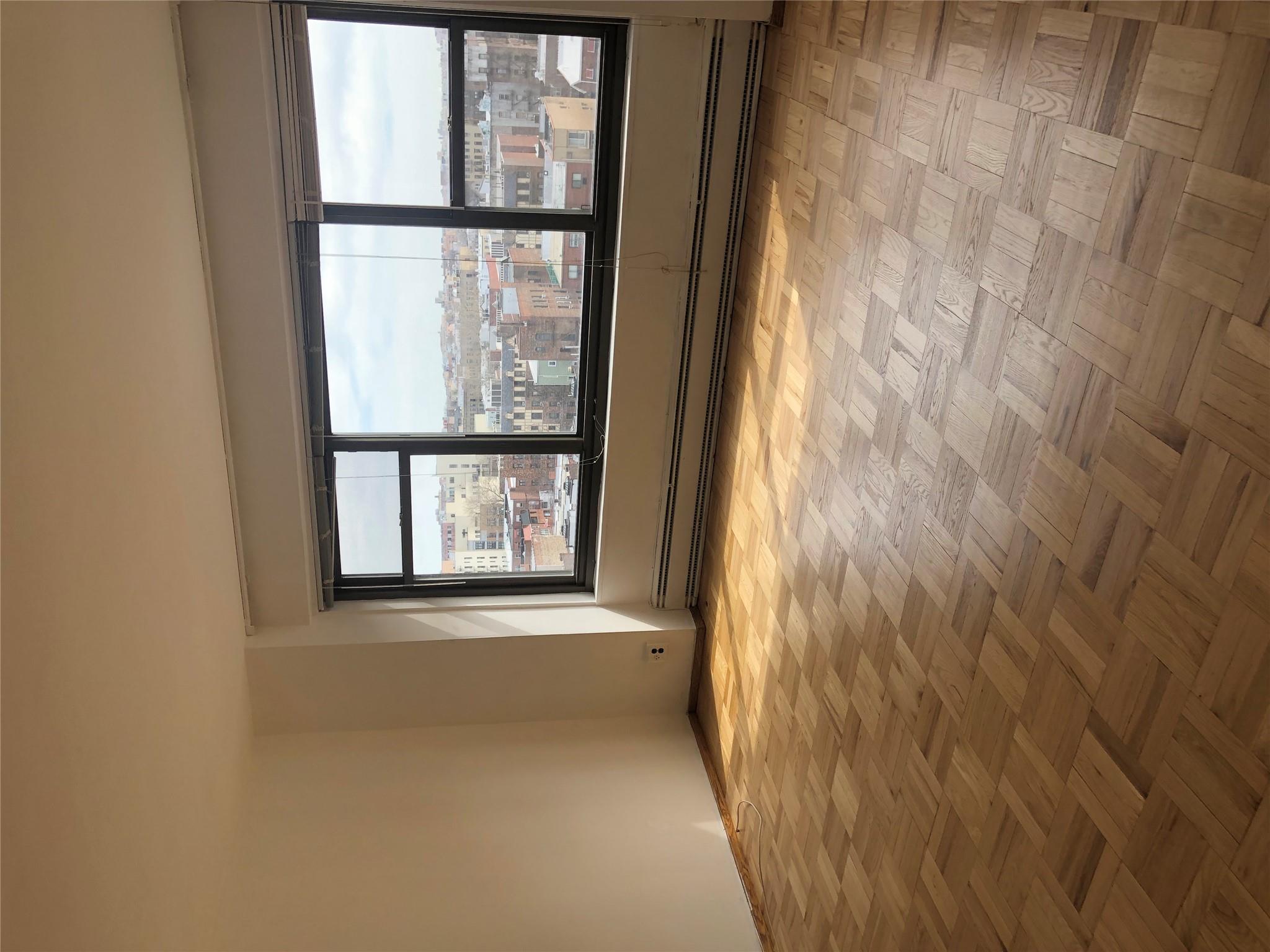 21-80 33rd Road, Unit 10A Queens, NY 11106 - Photo 1 of 14 a view of an empty room with a window