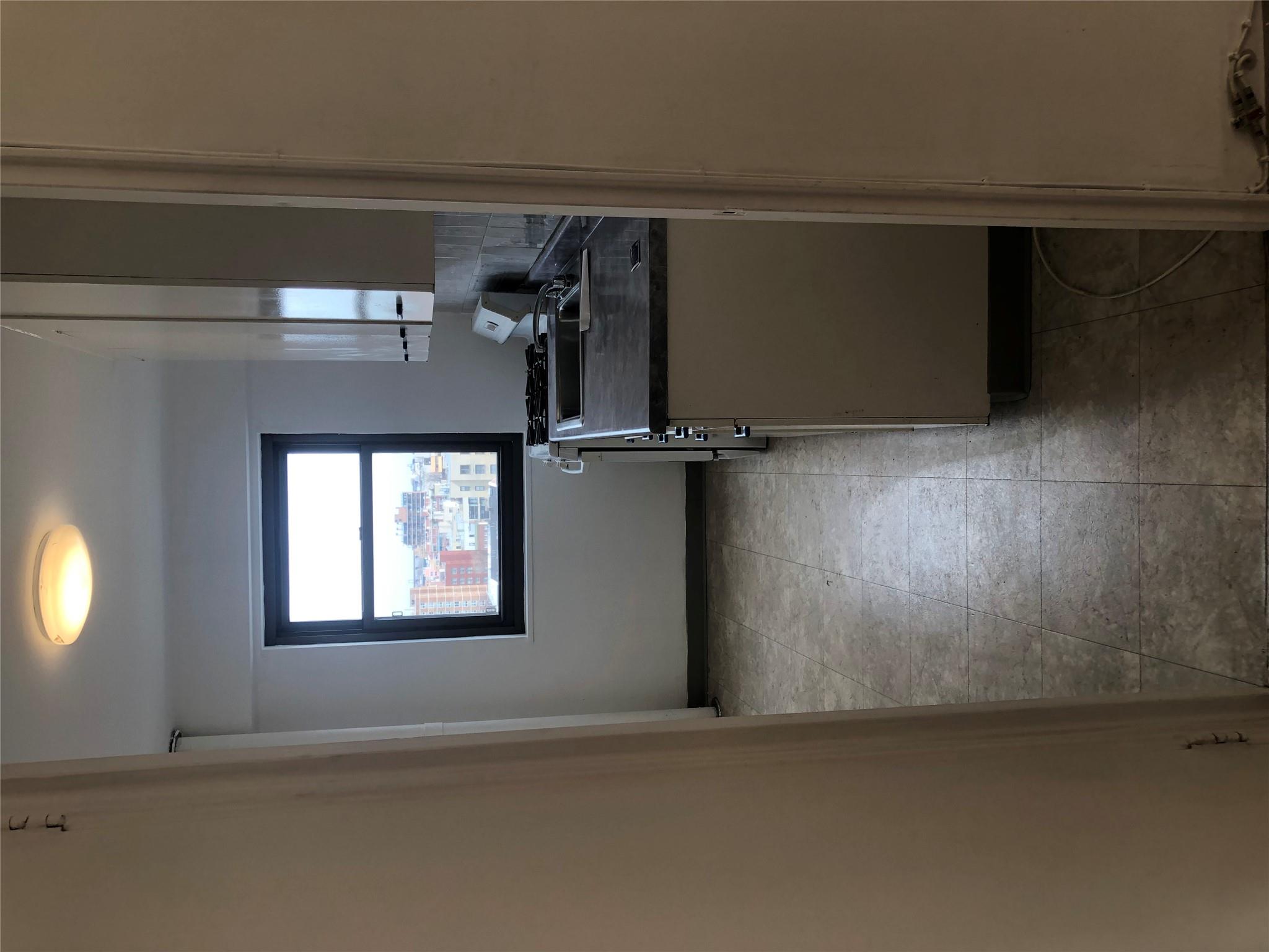 21-80 33rd Road, Unit 10A Queens, NY 11106 - Photo 12 of 14 a kitchen with a stove and a window