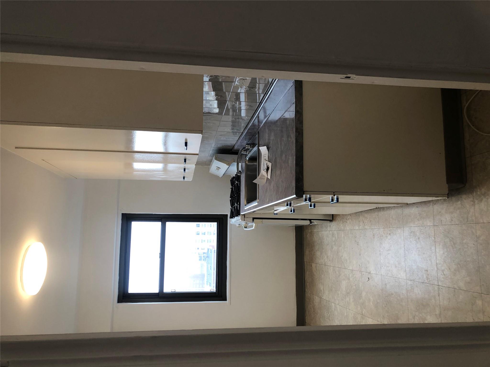 21-80 33rd Road, Unit 10A Queens, NY 11106 - Photo 4 of 14 a bathroom with a granite countertop sink a window and a mirror