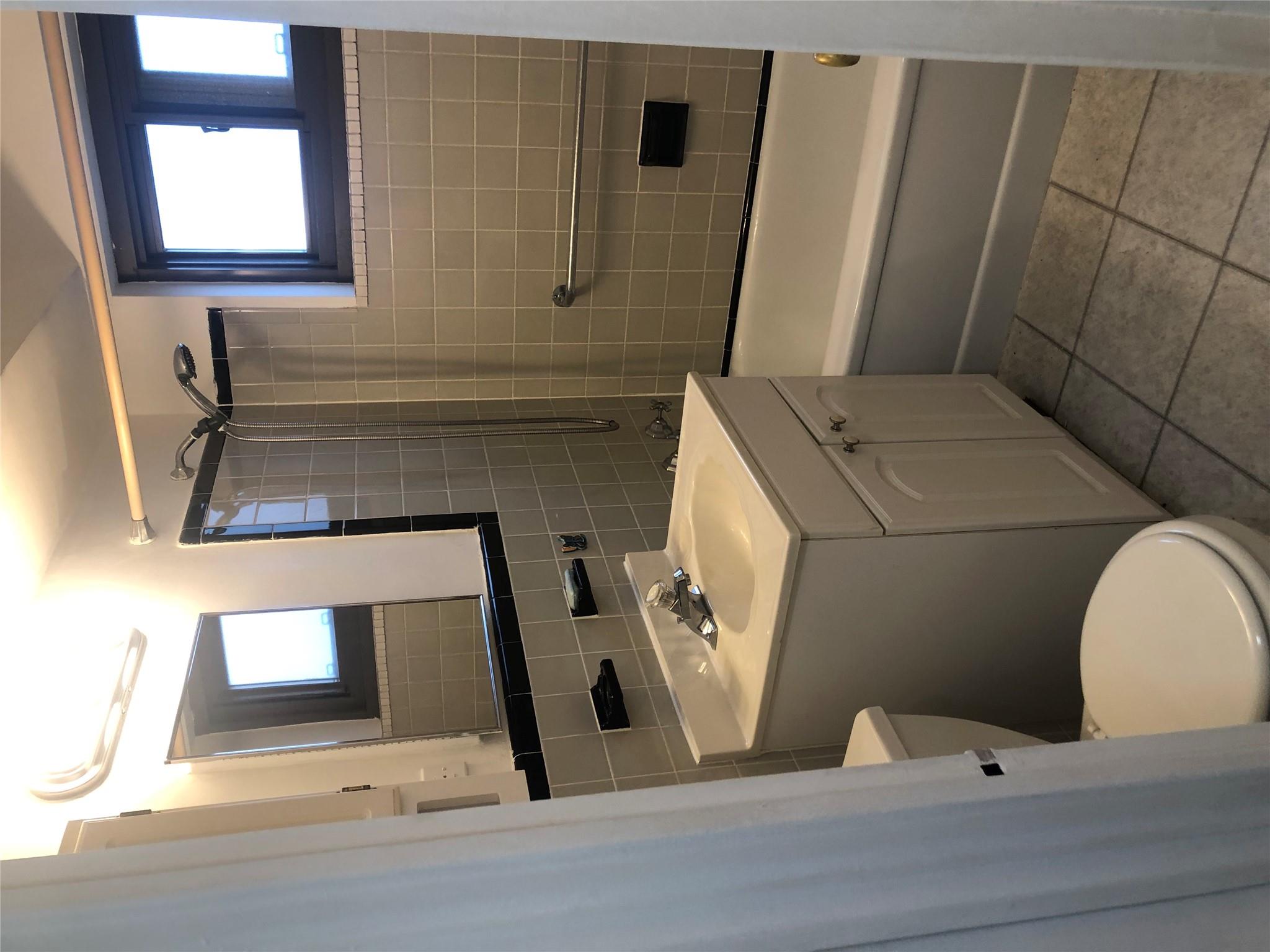 21-80 33rd Road, Unit 10A Queens, NY 11106 - Photo 7 of 14 a bathroom with a sink a toilet and a bathtub