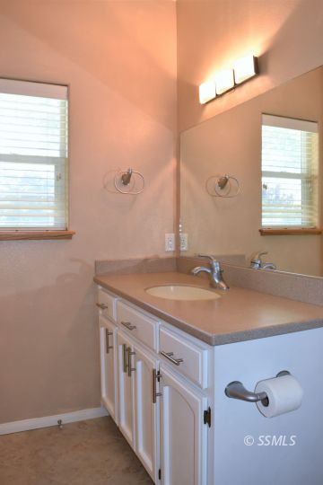 919 Sims Street Ridgecrest, CA 93555 - Photo 22 of 32 a bathroom with a granite countertop sink and a mirror