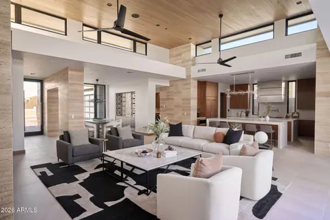 a living room with furniture a table and chairs