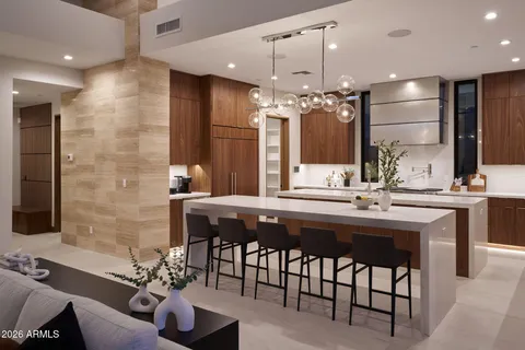 a bathroom with a sink a center island and chairs